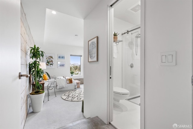 bathroom featuring toilet and an enclosed shower