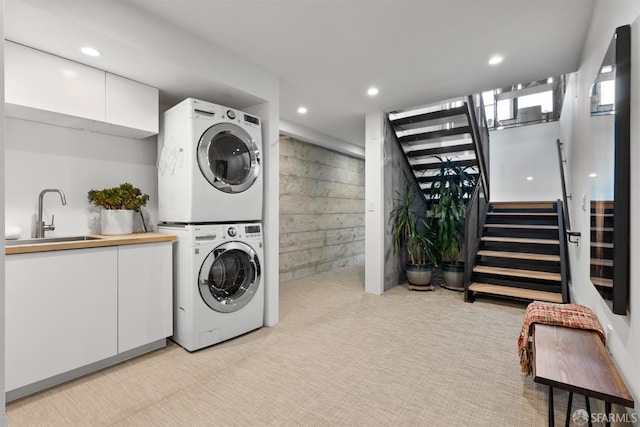 laundry room with sink and stacked washer and dryer