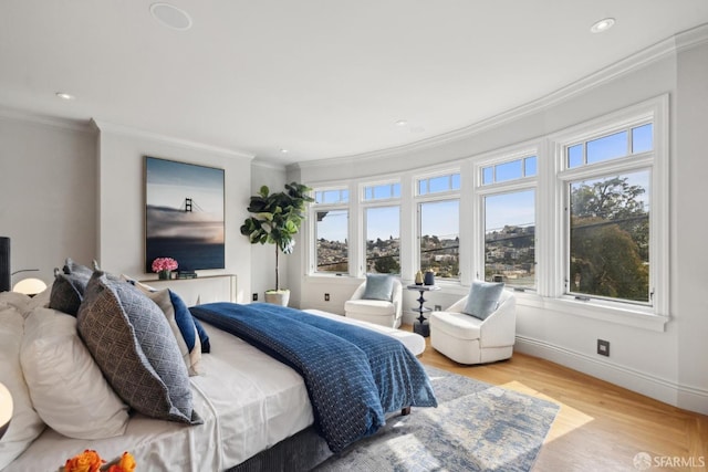 bedroom with baseboards, recessed lighting, wood finished floors, and crown molding