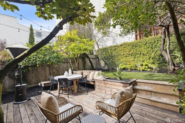 wooden terrace featuring outdoor dining space and fence