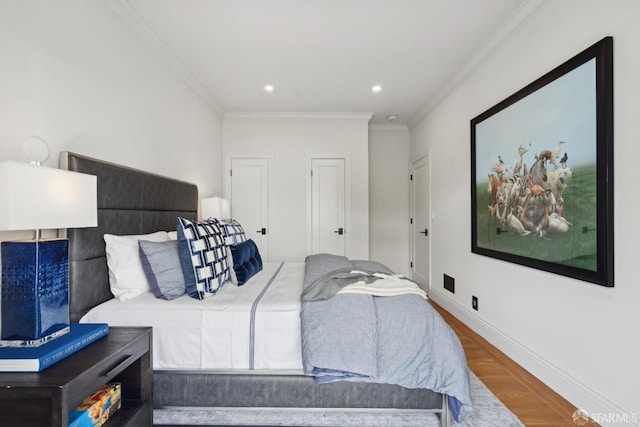 bedroom featuring ornamental molding, recessed lighting, wood finished floors, and baseboards