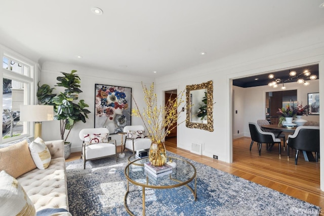 living room featuring wood finished floors, visible vents, and recessed lighting