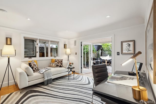 living area with recessed lighting, baseboards, and wood finished floors