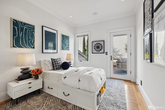 bedroom featuring access to exterior, crown molding, light wood-style flooring, and baseboards