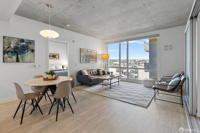 interior space featuring visible vents, baseboards, and wood finished floors