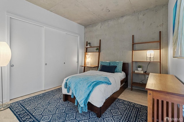 bedroom with a closet and wood finished floors