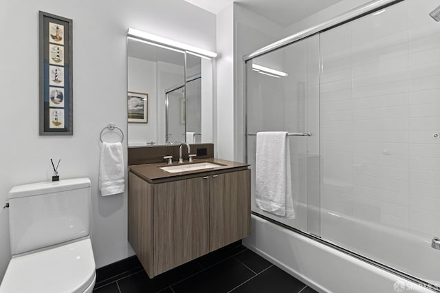 full bath with toilet, vanity, combined bath / shower with glass door, and tile patterned floors