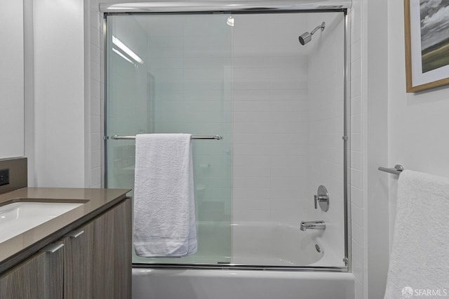 full bath featuring bath / shower combo with glass door and vanity