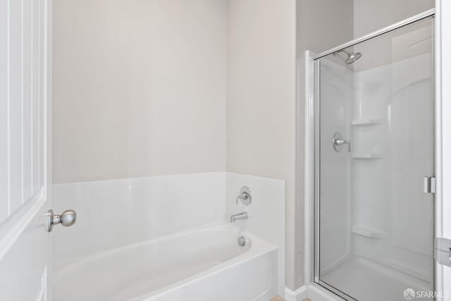 bathroom with separate shower and tub