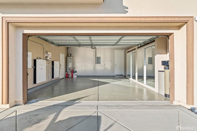 garage with electric panel and water heater