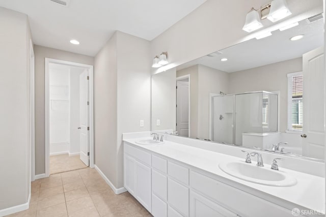 bathroom with vanity, tile patterned floors, and walk in shower