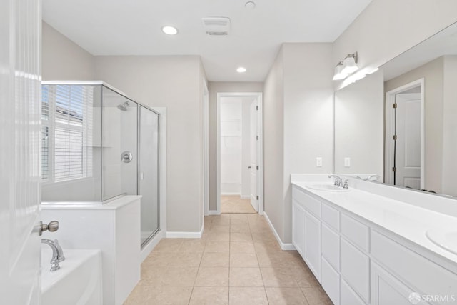 bathroom featuring tile patterned floors, plus walk in shower, and vanity