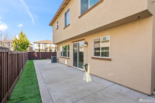 back of property featuring central AC and a patio area