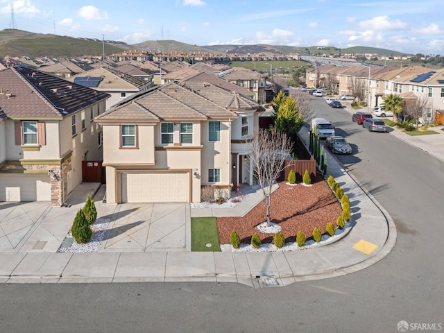 view of front facade featuring a garage and a mountain view