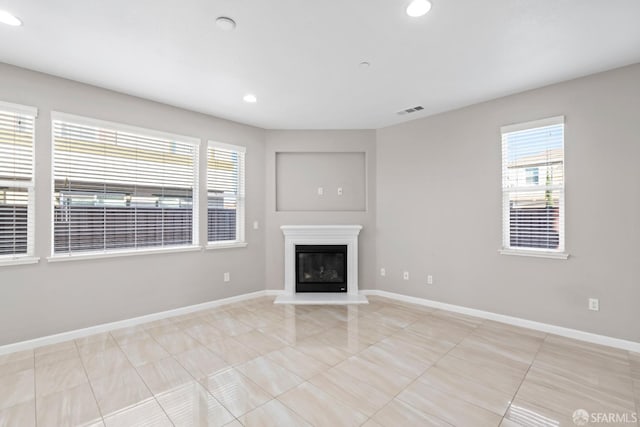 unfurnished living room featuring light tile patterned floors