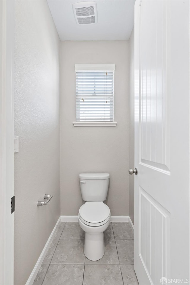 bathroom with tile patterned floors and toilet