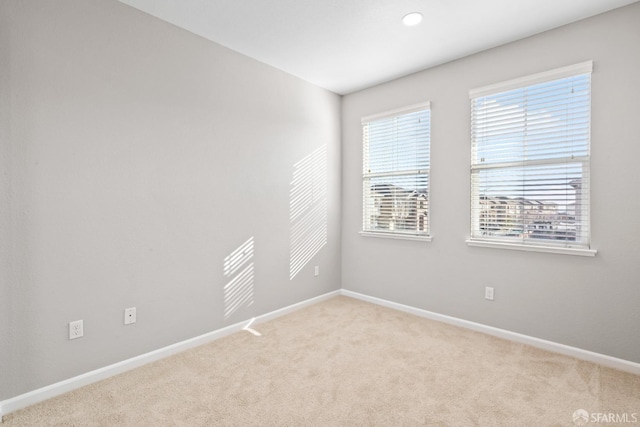 spare room with light colored carpet