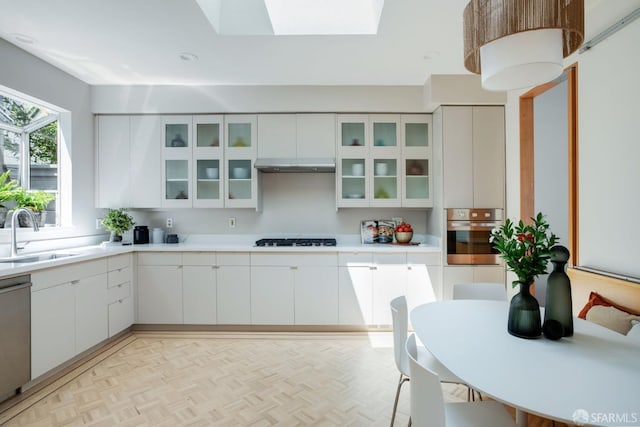 773 Duncan St, San Francisco, CA 94131 - kitchen featuring appliances with stainless steel finishes, a sink, under cabinet range hood, white cabinets, and light countertops