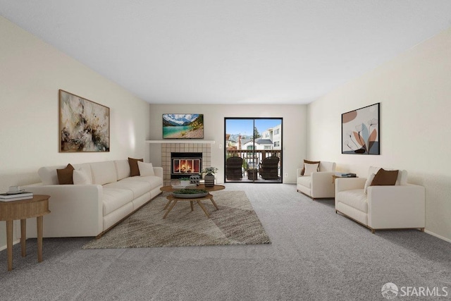 living area featuring carpet and a fireplace