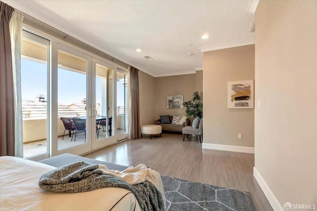 bedroom with crown molding, access to outside, and wood-type flooring