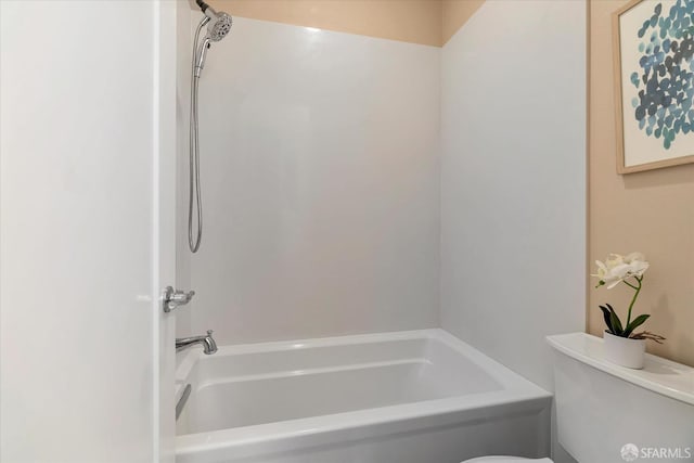 bathroom featuring a tub to relax in and toilet