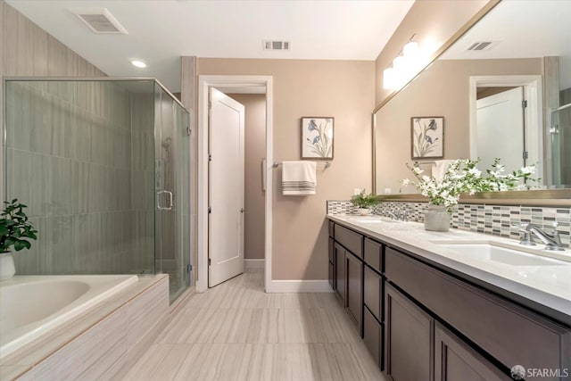 bathroom with vanity, tasteful backsplash, and shower with separate bathtub