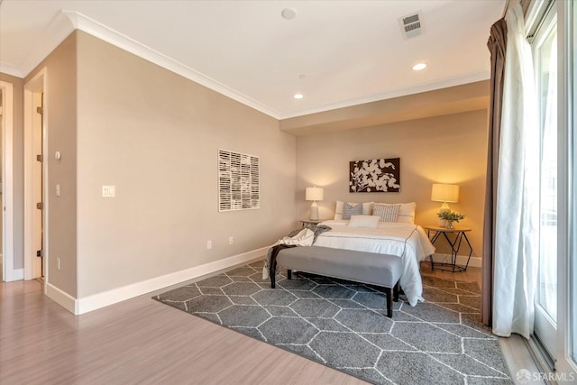 bedroom featuring hardwood / wood-style flooring and crown molding