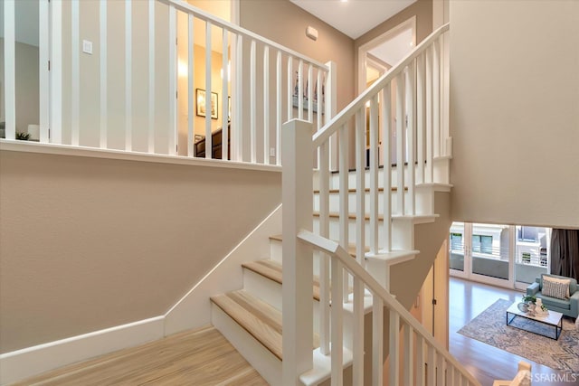 stairs featuring hardwood / wood-style flooring