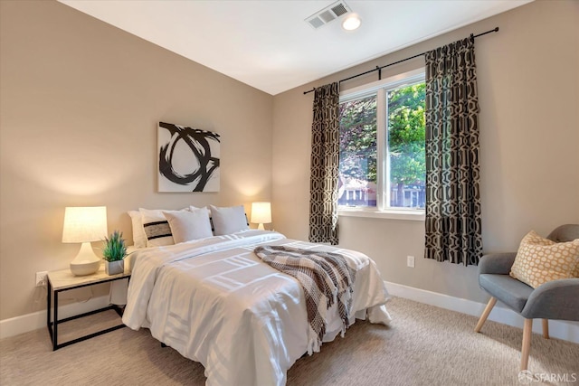 carpeted bedroom with multiple windows