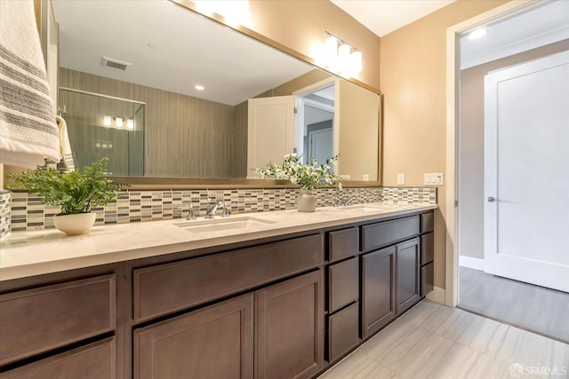 bathroom with vanity, a shower, and tasteful backsplash