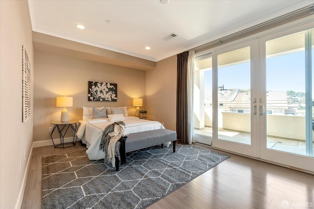 bedroom with ornamental molding, dark hardwood / wood-style flooring, access to exterior, and french doors