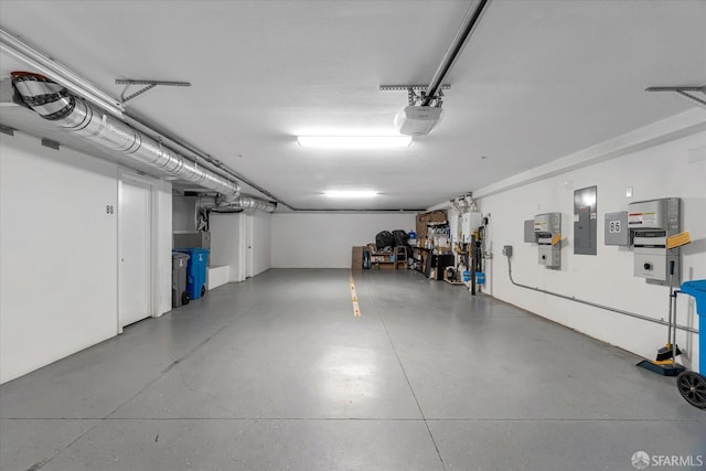 garage with a garage door opener and electric panel