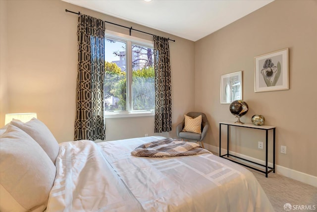 bedroom featuring light carpet and multiple windows