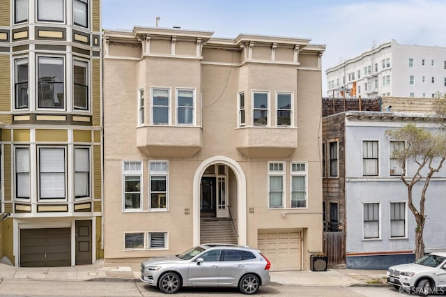 2922 Pine St, San Francisco, CA 94115 - view of property with a garage, stucco siding, and driveway