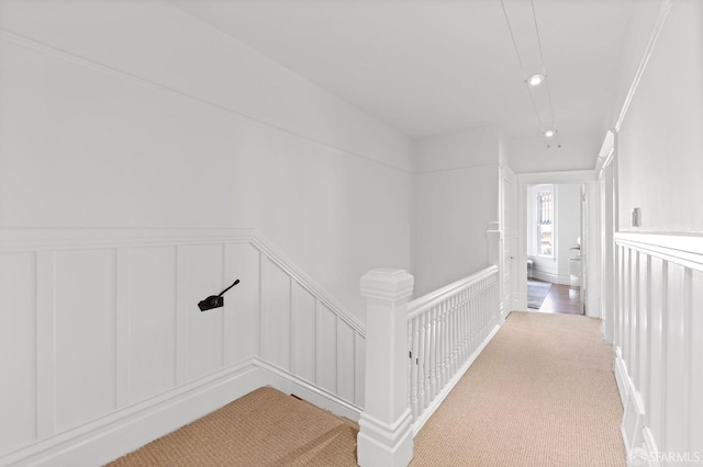 hall featuring crown molding and carpet floors