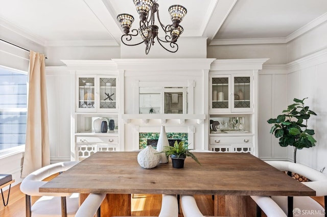 dining area featuring crown molding, a notable chandelier, and wood-type flooring