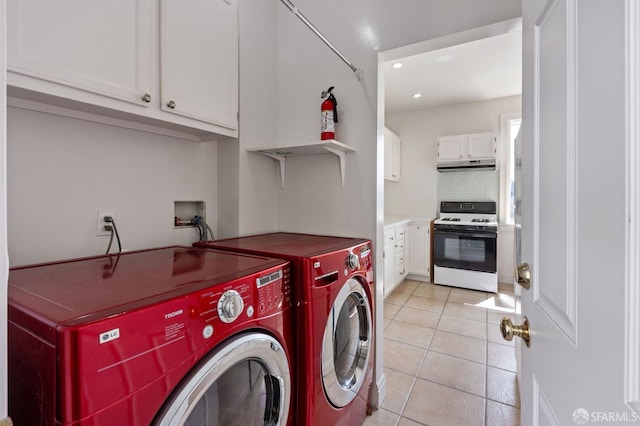 laundry room with cabinets, separate washer and dryer, and light tile patterned floors