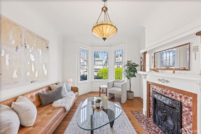 sitting room with a fireplace and wood-type flooring