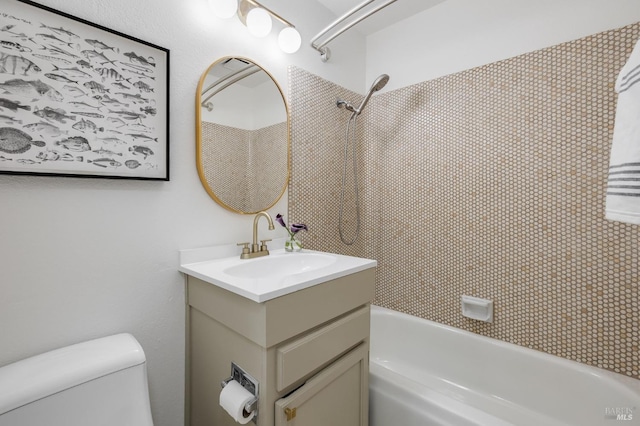 full bathroom with vanity, tiled shower / bath combo, and toilet