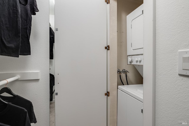 washroom with stacked washing maching and dryer