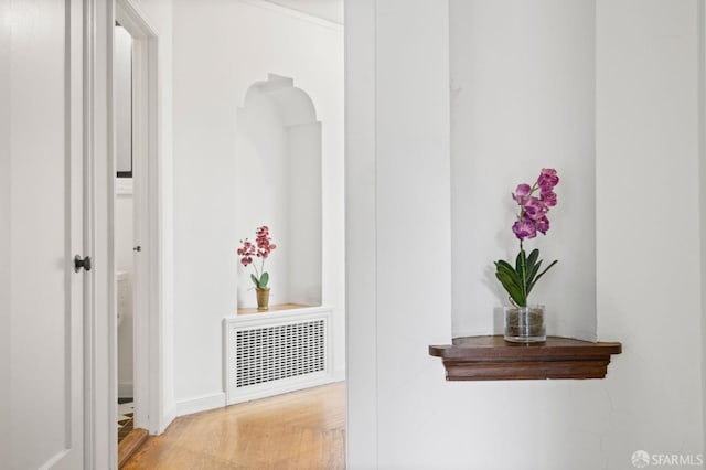 hallway with light hardwood / wood-style floors