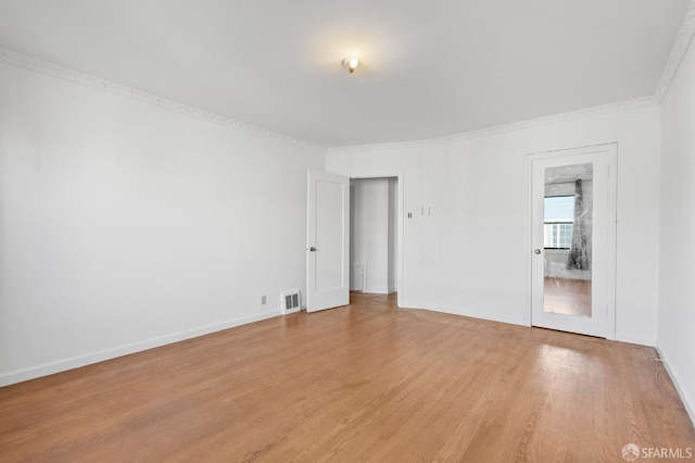 unfurnished room featuring crown molding and light hardwood / wood-style flooring