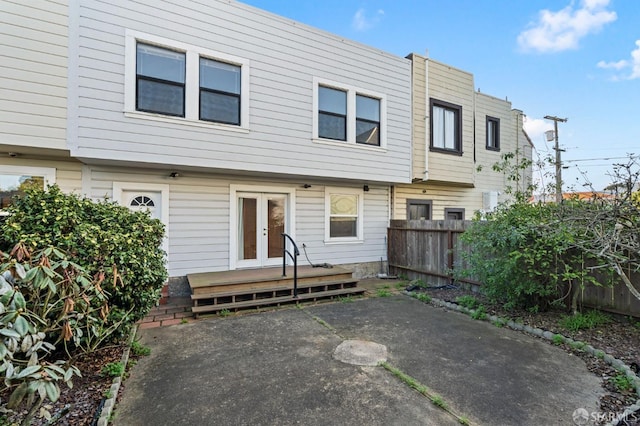 back of house featuring a patio area, a wooden deck, and french doors