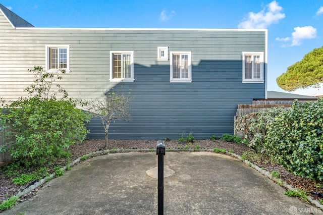 view of side of property with a patio area