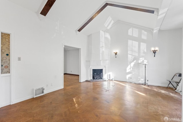 unfurnished living room featuring beam ceiling, a large fireplace, high vaulted ceiling, and parquet floors