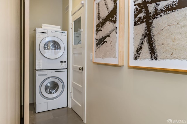 laundry room featuring stacked washer and dryer and laundry area