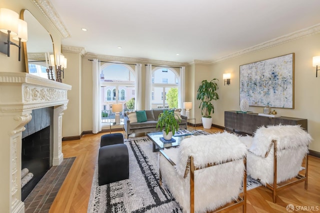 living room featuring a fireplace, baseboards, and crown molding