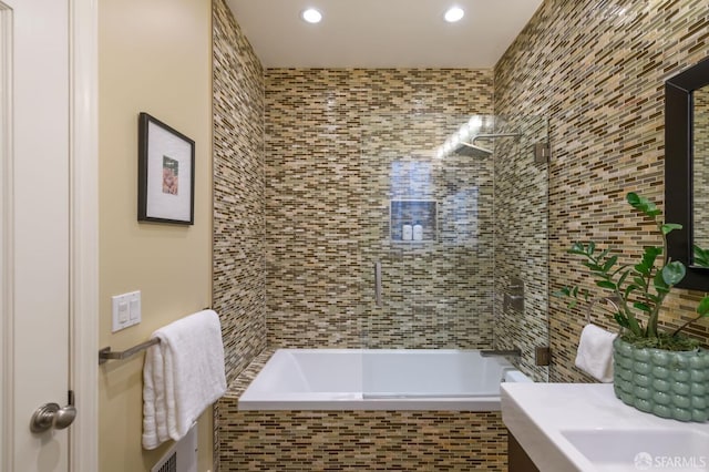 bathroom featuring tiled shower / bath combo, vanity, and recessed lighting