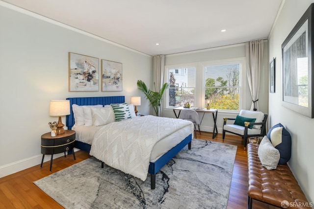 bedroom featuring recessed lighting, multiple windows, baseboards, and wood finished floors