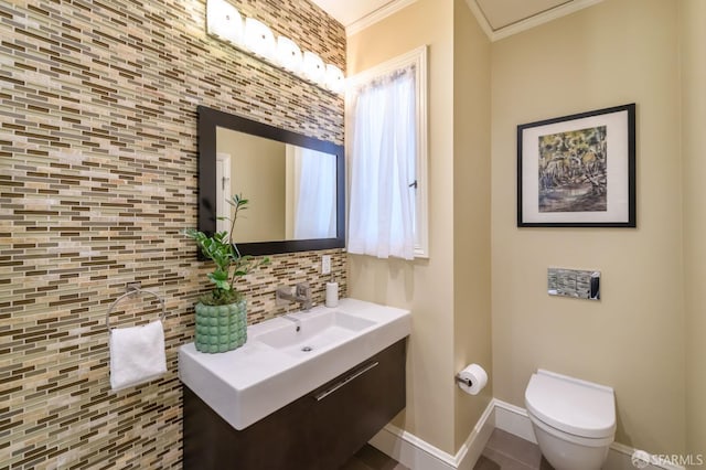 half bath featuring crown molding, backsplash, toilet, vanity, and baseboards